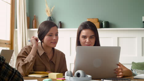 Camera-Focuses-On-Two-Girls-Of-A-Study-Group-Who-Are-Talking-And-Looking-At-Laptop-1