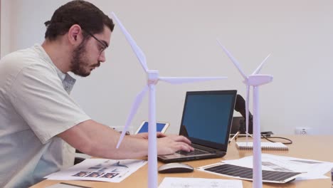 dedicated engineer programming on laptop for wind turbine management system