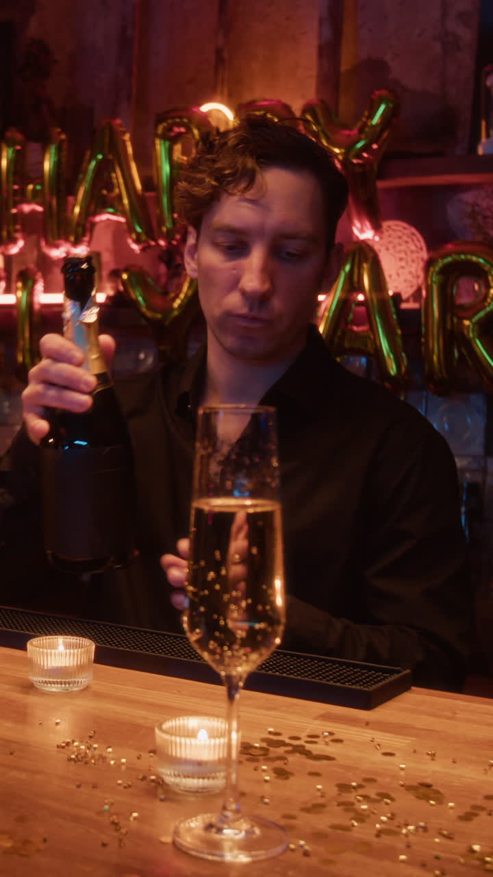 Bartender preparing champagne for New Year's Eve celebration