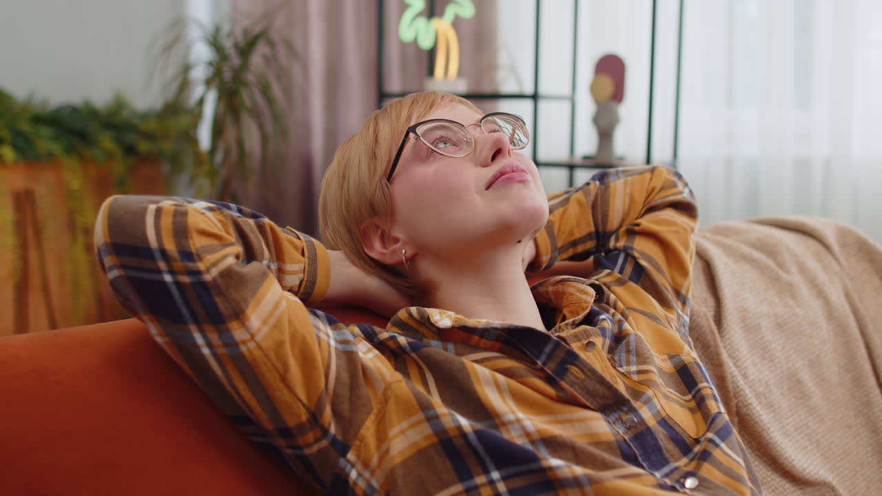 Tired lazy woman enjoy relaxing on home sofa resting napping after hard working day closed her eyes
