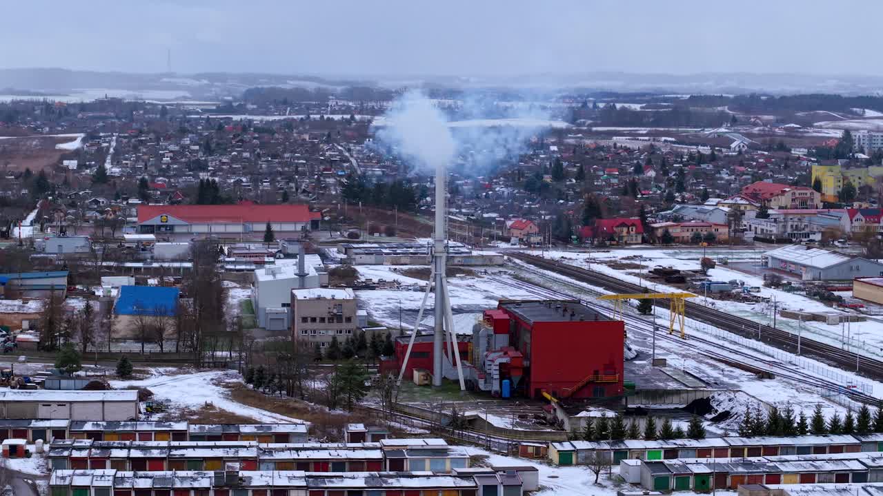 Aerial winter view of a small heat plant in Elk, Poland, with railway tracks nearby