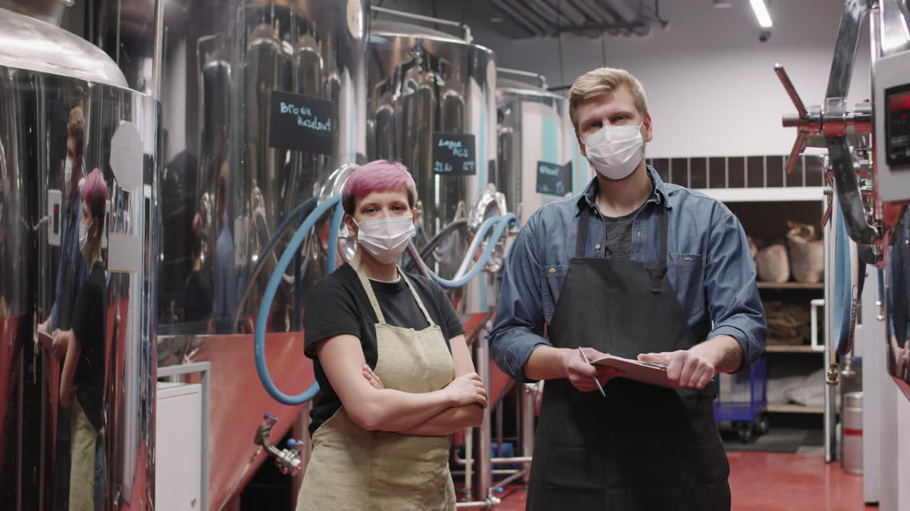 Portrait Of Brewery Workers Couple In Masks
