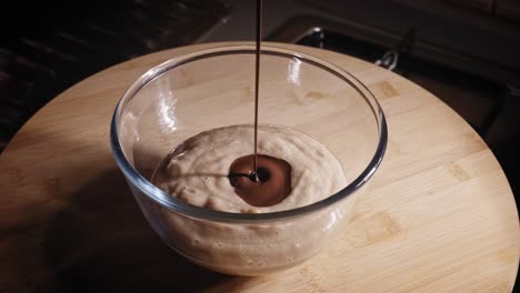 pouring melted dark chocolate into bowl with blended banana