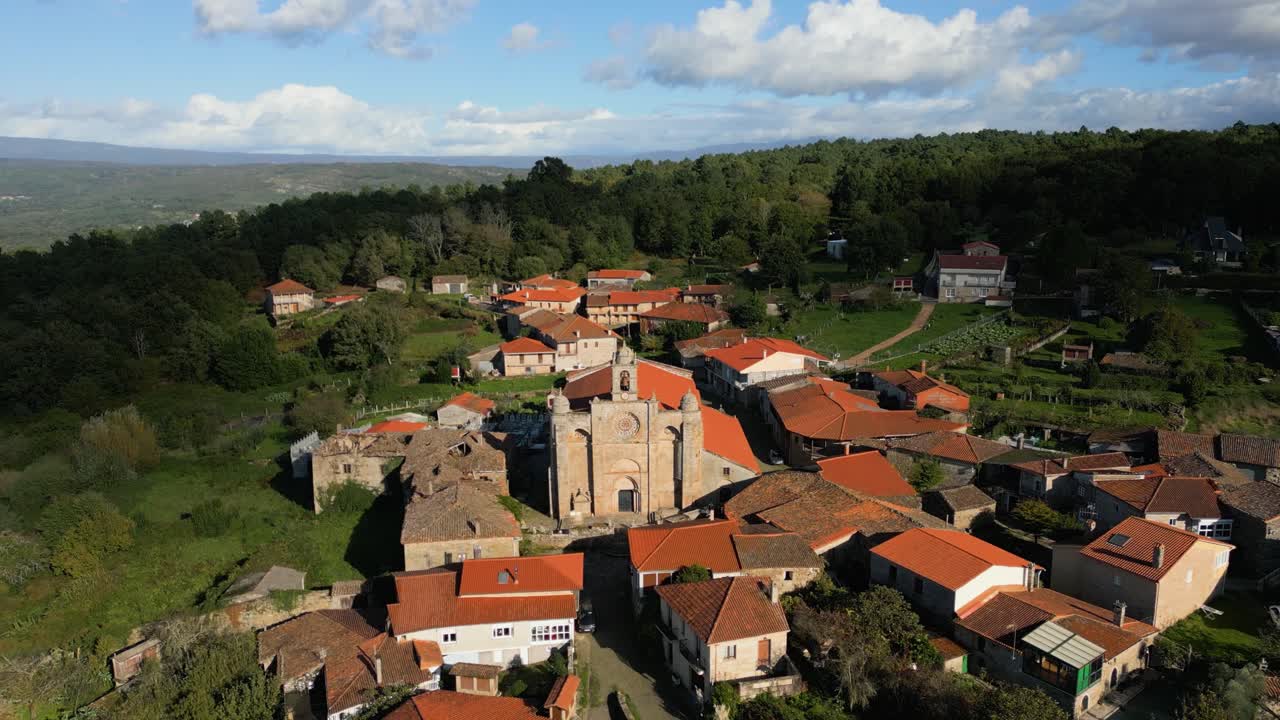 Aerial view of the Church of Santa Mariña in Allariz, capturing the building's stone architecture and rural surroundings.