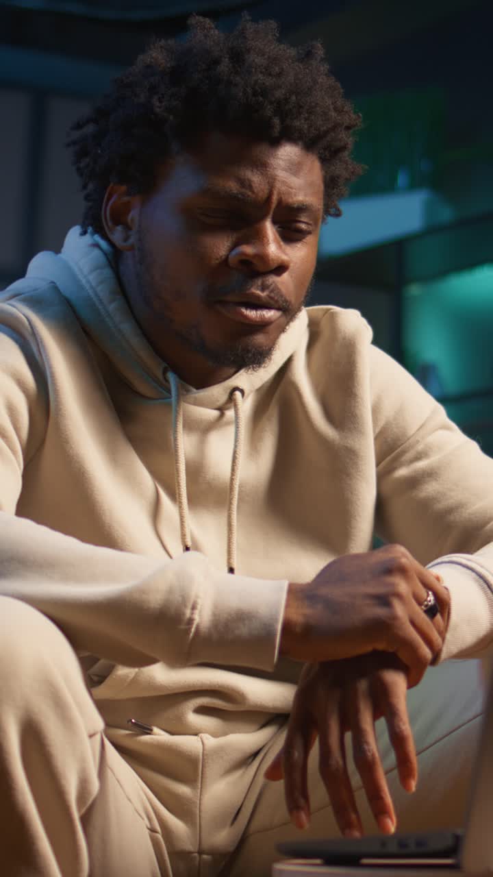Young Black Man Speaking and Gesturing in Online Meeting