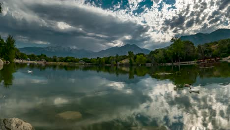 Cloudscape-above-the-pond-and-mountains-with-the-dynamic-clouds-reflecting-off-the-surface-of-the-water---static-time-lapse