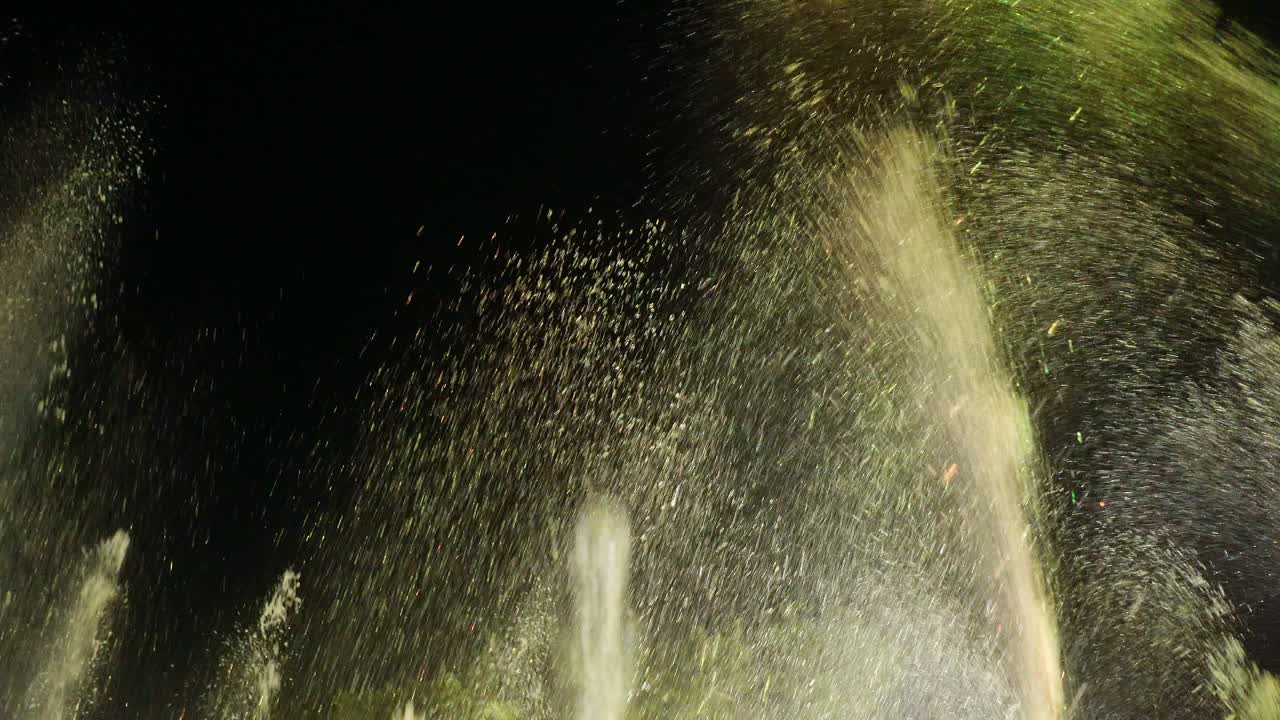 Low-angle view of water spraying in a musical fountain.
