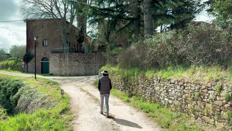 woman walking outside old rustic italian cottage in tuscany countryside