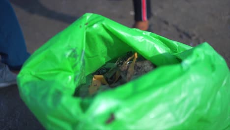 garbage is put in the garbage bag closeup view in mahim beach in mumbai