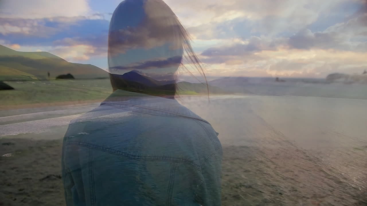 On beach, silhouette of person blending with scenic landscape animation overlay