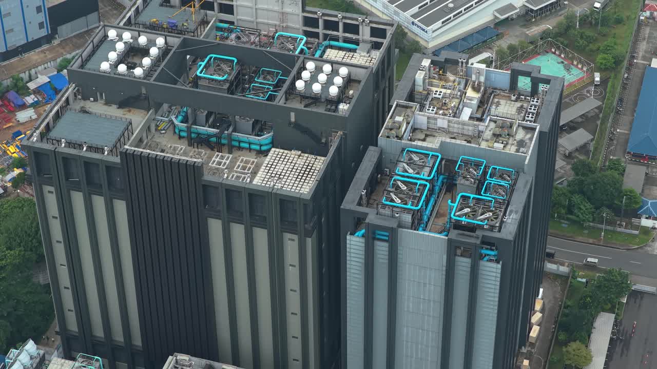 Aerial view circling over the rooftop of a modern data center building, showing its advanced cooling system and hvac units in jakarta