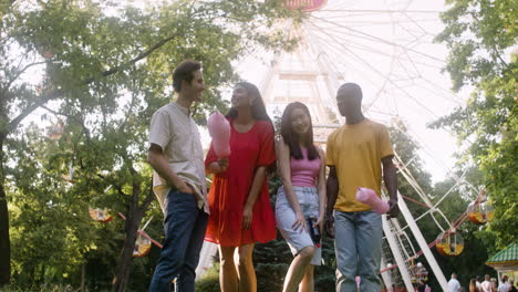 four people posing in a park