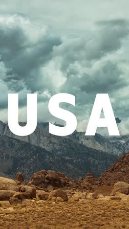 Vertical-Video-Of-Mountains-And-Desert-Landscape-In-American-National-Park-Overlaid-With-Animated-Graphic-Spelling-Out-USA