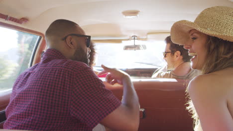 group of friends relaxing in car during road trip