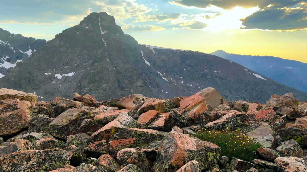 Mount of the Holy Cross 14er peak boulder rocks summer spring sunset golden hour clouds sun rays drone Halo Ridge trail Notch Sawatch Range Rocky Mountains snow on summit North ridge slide left