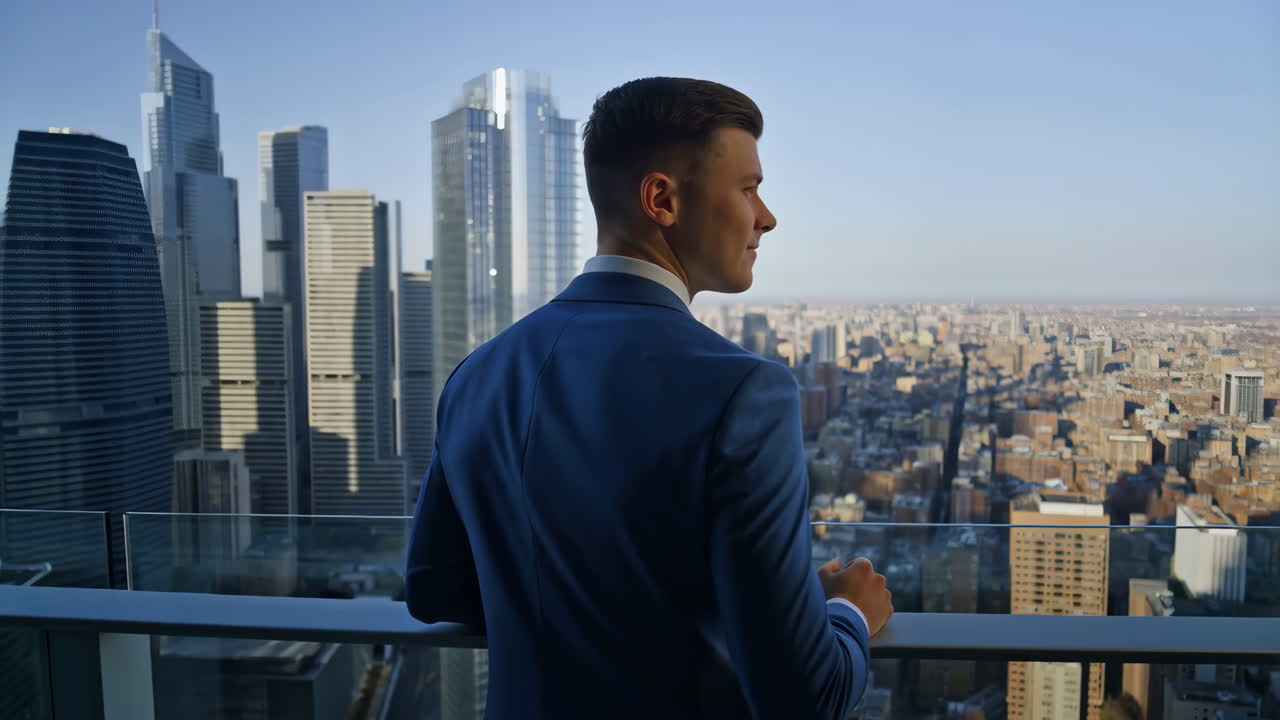 Businessman Looking Out at City Skyline from High-Rise Balcony