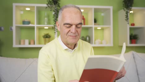 Mature-man-reading-a-book-at-home.-Knowledge-and-culture-concept.