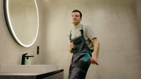 plumber dancing in a modern bathroom