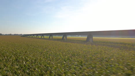 Low-Aerial-Over-Green-Fields-With-Maglev-Transrapid-Test-Track-In-Lathen,-Germany