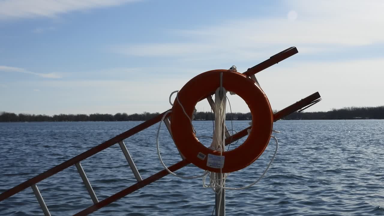 Buoy tied on ladder against river water background. Static