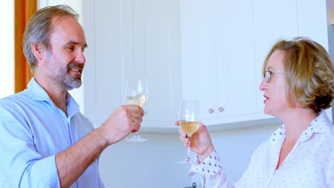 couple toasting glasses of champagne in kitchen 4k