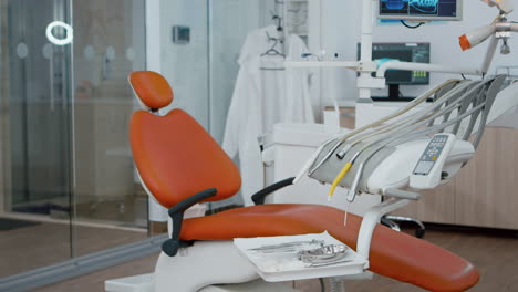 revealing shot of orthodontist dentistry chair with nobody in, prepared for teeth dental health.