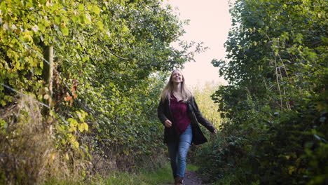 woman walking on forest trail