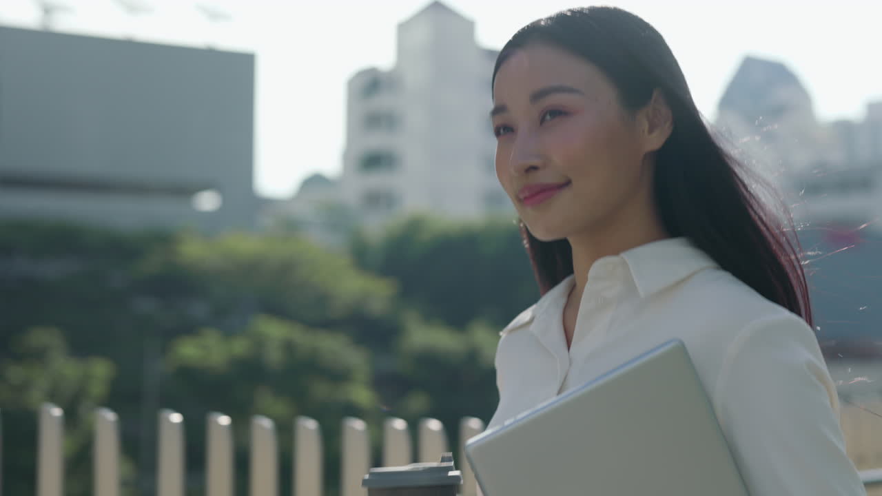 Young Asian Businesswoman Walking in City with Laptop and Coffee