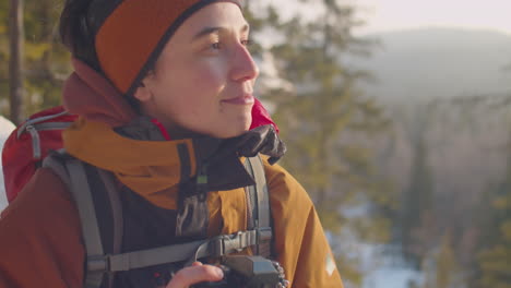 female photographer taking pictures of nature during winter hike
