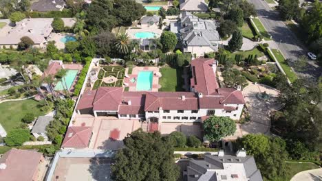 Aerial-rising-view-overlooking-sunny-San-Marino-suburban-neighbourhood-community-residential-district