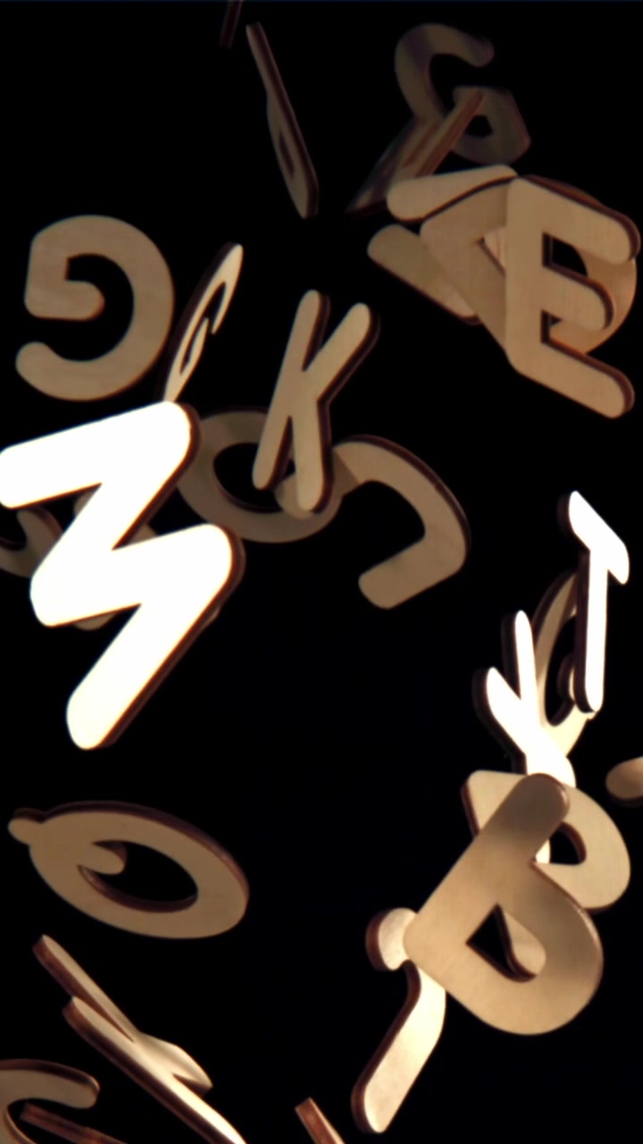 Wooden Alphabet Letters Floating Up on Black Background