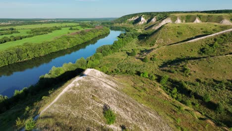 aerial view of river valley with hills and forests