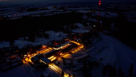 night view of illuminated streets of zakopane town during winter in poland - aerial drone shot