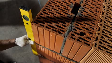 bricklaying process with level and hammer