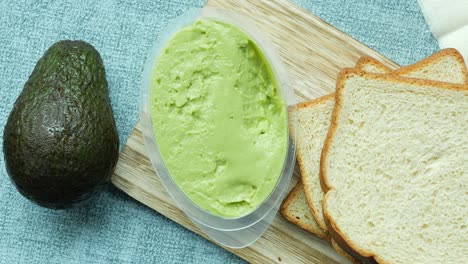 Avocado-spread-on-a-chopping-board-,