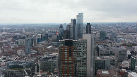 Crane-up-footage-of-modern-buildings.-Principal-Tower-and-revealing-skyscrapers-in-City-business-district.-Panoramic-aerial-view-on-large-town.-London,-UK