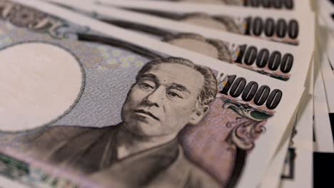 japanese currency 100,000 yen on the black background panning