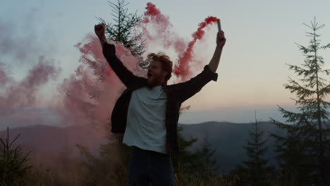 man jumping in air with smoke flare in hand