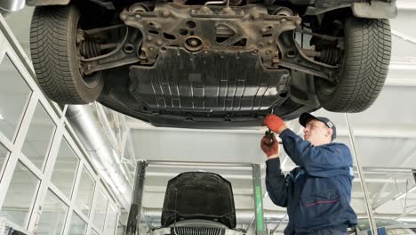 car undercarriage maintenance by mechanic