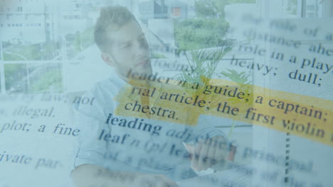 dictionary text animation over man working on laptop in outdoor setting