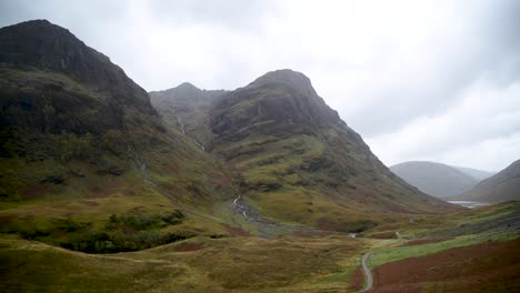 180-degree-view-of-a-large-mountain-range-with-hiking-tracks-and-waterfalls-in-the-Highlands-of-Scotland