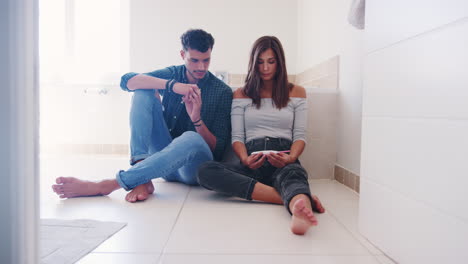 couple waiting for result of home pregnancy test in bathroom