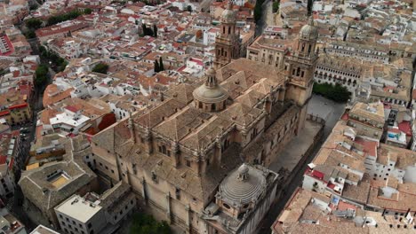 Spain-Jaen-Cathedral,-Catedral-de-Jaen,-flying-shoots-of-this-old-church-with-a-drone-at-4k-24fps-using-a-ND-filter-also-it-can-be-seen-the-old-town-of-Jaen