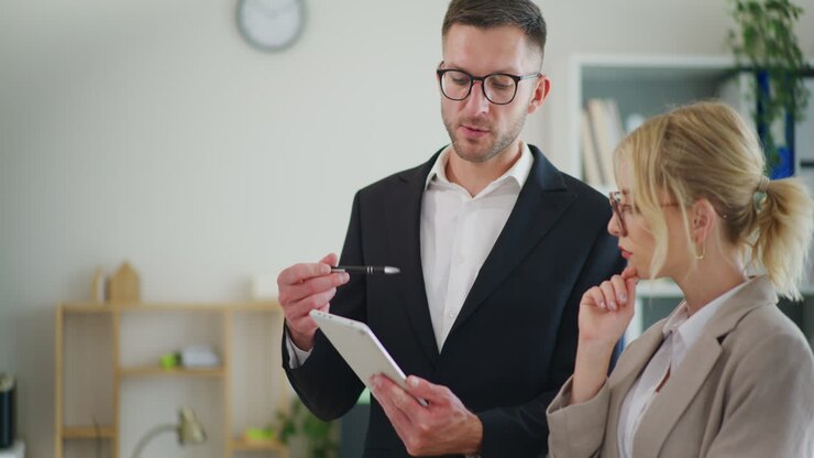 Businessman Discusses Project with Colleague in Office