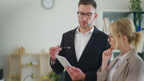 businessman discusses project with colleague in office