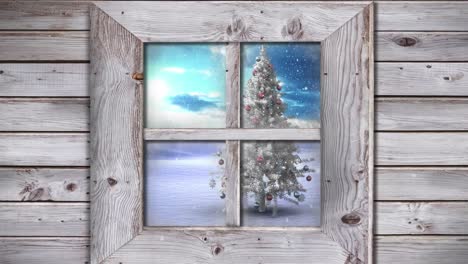 Wooden-window-frame-against-snow-falling-over-christmas-tree-on-winter-landscape