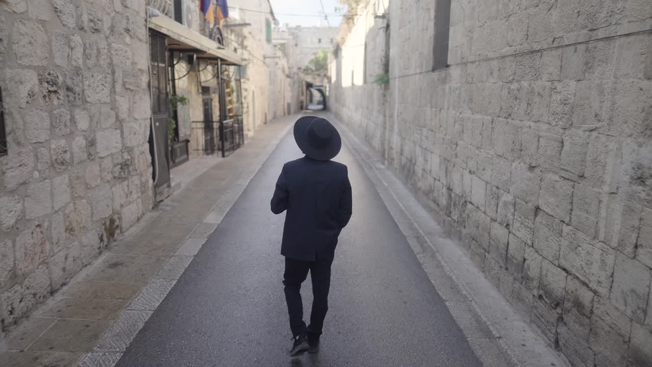 Orthodox Jew walking through alleyway in the Old City of Jerusalem, Israel