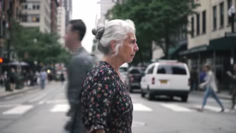 a reflective moment: an elderly woman pauses in a busy urban street, capturing the essence of daily life in the city with a sense of contemplation and awareness.