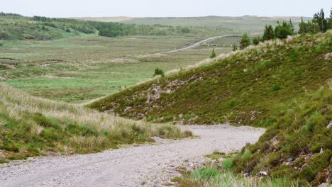 shot of a gravel road with a peat bank and moor