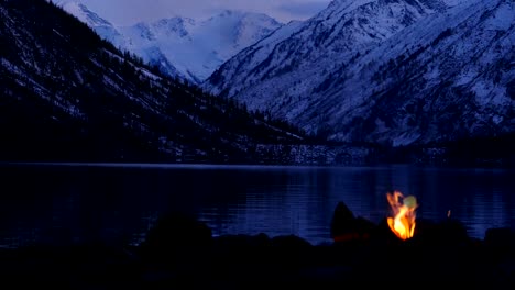 camp fire near mountain lake twilight seamless loop